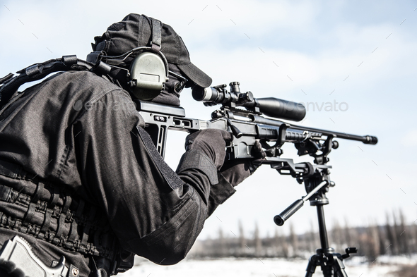 Equipped police SWAT sniper shooting with rifle - Stock Photo - Images