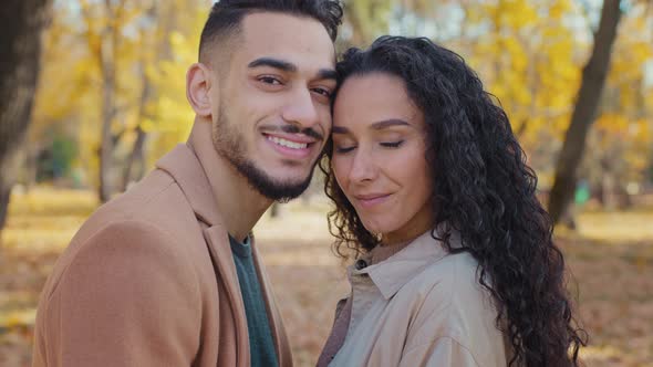 Closeup Hispanic Couple in Love Looking at Camera Guy and Girl Smiling Happily Stand Close to Each alt