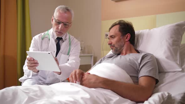 Male Doctor Showing MRI Results To Patient alt