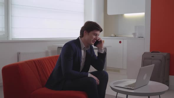 Male Has Phone Conversation with Partner Indoors alt