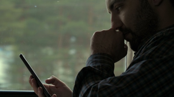 Young concentrated man making money transaction via application alt