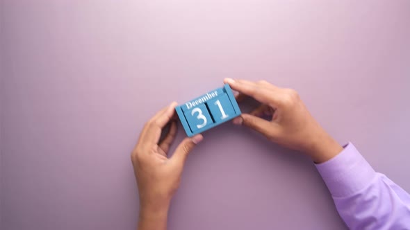 Wooden Calendar Set on 31Th December on Purple Background alt