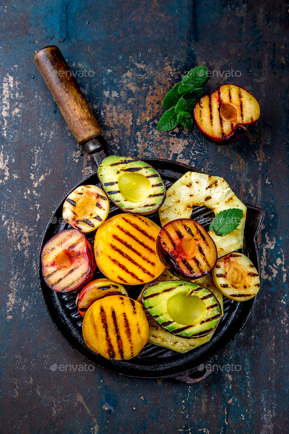 Grill Fruits - Pineapple, Peaches, Plums, Avocado, Pear on Black Cast Iron Grill Pan