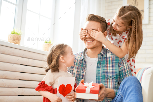 daughters congratulating dad - Stock Photo - Images