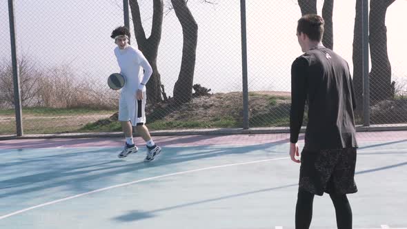 Two Basketball Player Playing Basketball Outdoors Slow Motion alt