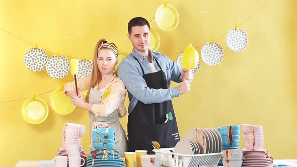 Positive Man and Woman Enjoying Washing the Dishes