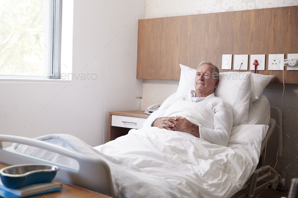 Senior Male Patient In Hospital Bed In Geriatric Unit - Stock Photo - Images