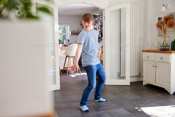 Young Downs Syndrome Man Having Fun Dancing At Home Stock Photo by ...