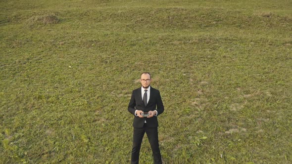 Businessman Professional Operate Drone Outdoor Standing on Green Grass Meadow