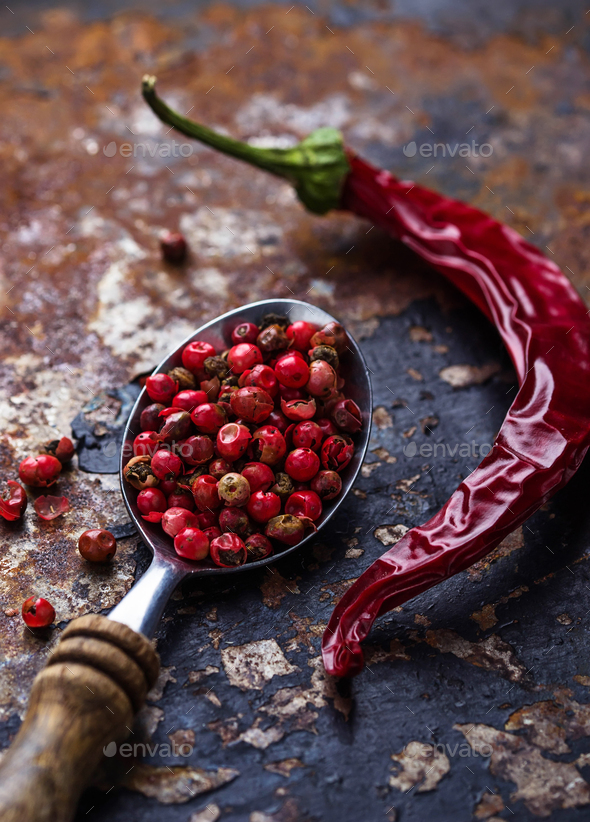 Red chili peppers and rose pepper on slate background