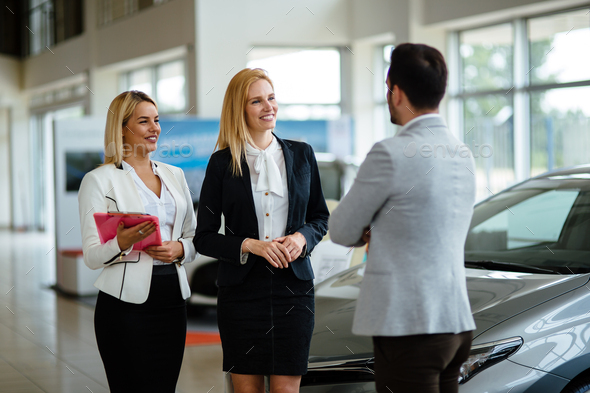 Professional gorgeous saleswoman at car dealership in formal wear. Super consultant and manager