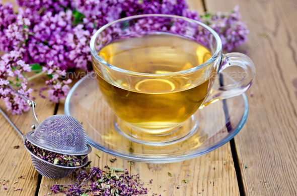 Herbal tea of oregano with strainer in a glass cup - Stock Photo - Images