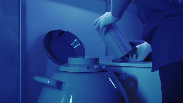 Specialist Embryologist Takes a Capsule With Embryos From the Cryobank