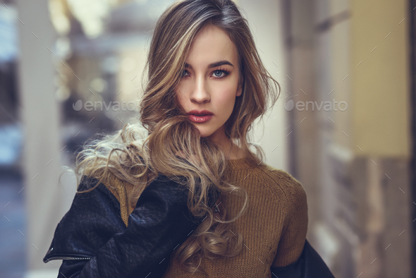 Beautiful blonde russian woman in urban background - Stock Photo - Images