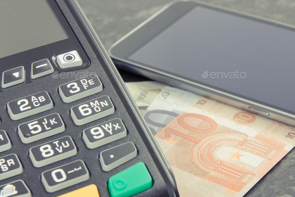 Payment terminal, money and smartphone with NFC technology using for cashless paying - Stock Photo - Images