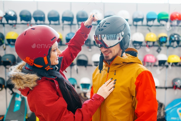 Couple check the strength of the ski helmet - Stock Photo - Images
