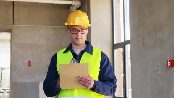 Male Builder with Clipboard Looking Up