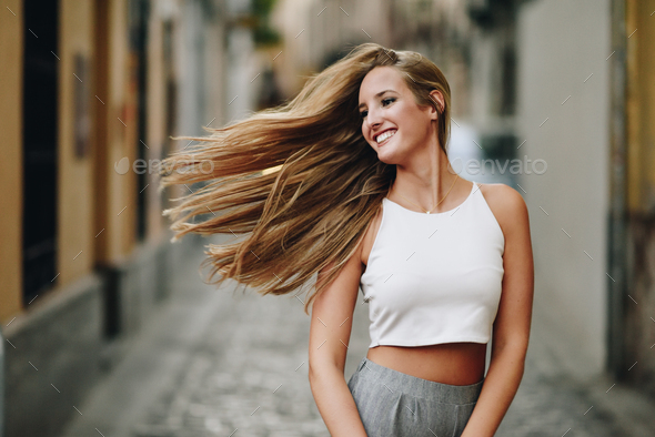 Young Woman With Nice Hair Wearing Casual Clothes In Urban