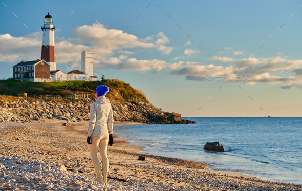 Woman tourist at the beach near Montauk Lighthouse - Stock Photo - Images