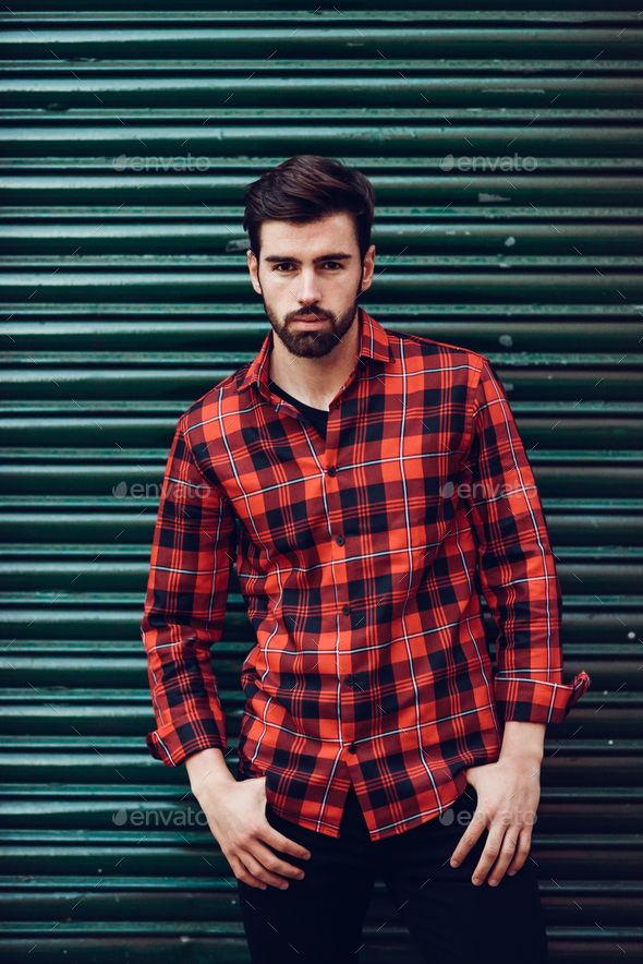 Young bearded man, model of fashion, wearing a plaid shirt with Stock ...