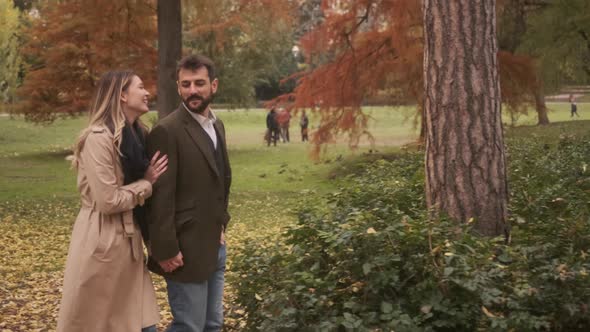 Handsome young couple walking in the autumn park