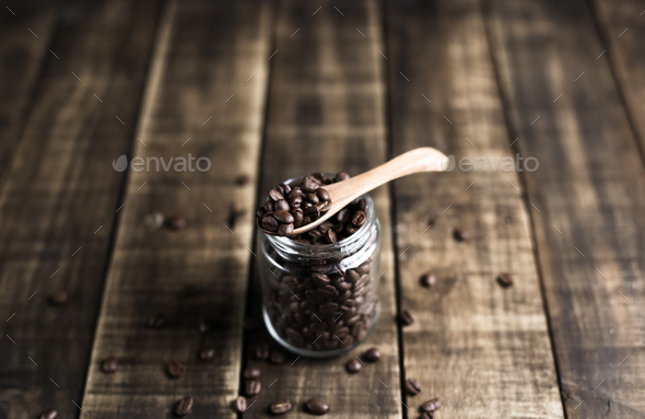 coffee beans in a jug and wooden spoon