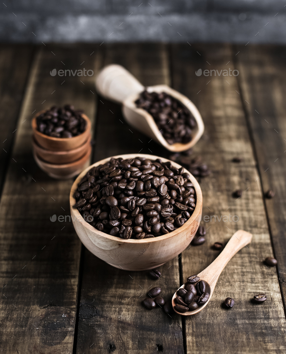coffee beans with wooden bowl scoop saucer and spoon