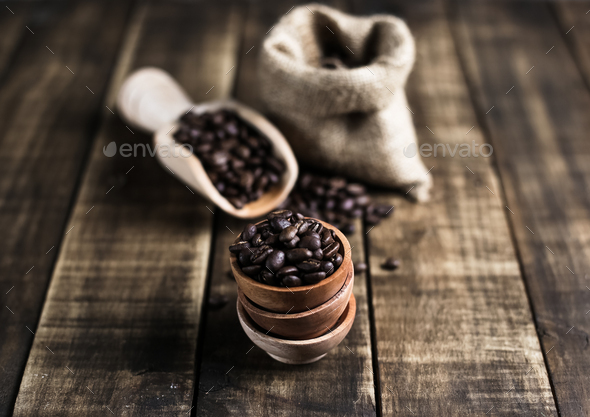 coffee beans with wooden saucer scoop and bag