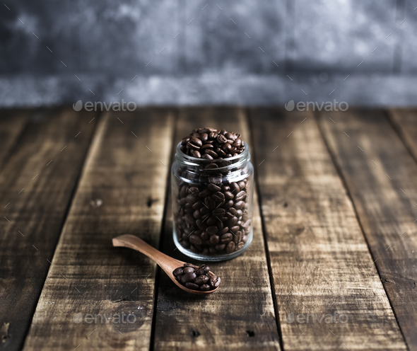 coffee beans in a jug and wooden spoon