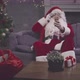 Man in Santa Claus Costume Taking Selfie on Smartphone Sitting on Couch - VideoHive Item for Sale