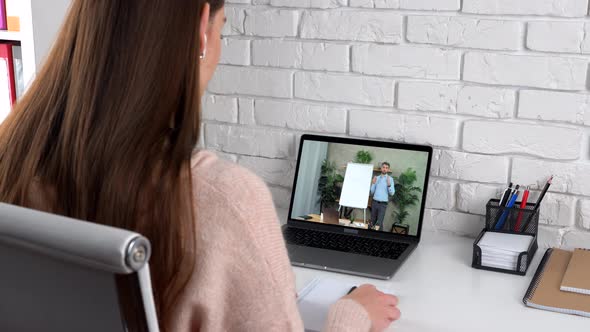 Woman in Home Study Watch Online Course Laptop Write in Notebook Listen Teacher alt