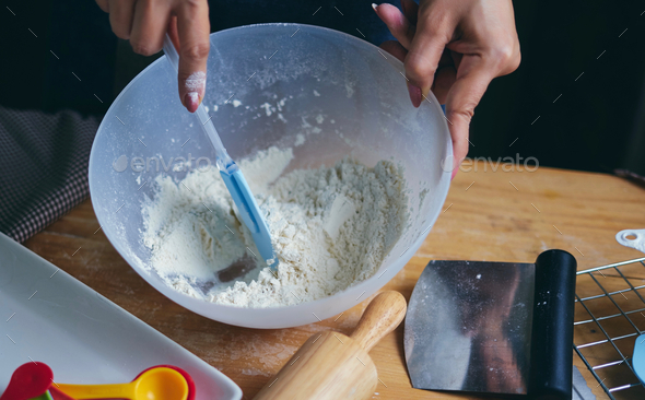 Chef mixes the flour in mixing bowl - Stock Photo - Images