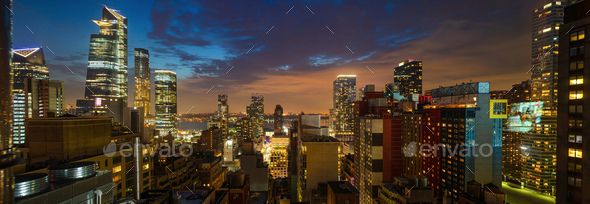 Panoramic view of Manhattan skyscrapers lights, New York city, in the evening - Stock Photo - Images