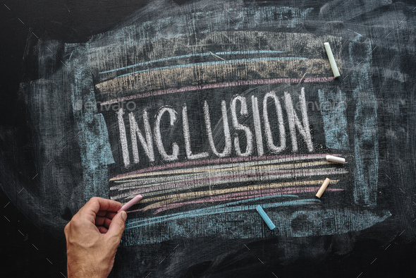 Teacher writing word Inclusion on school blackboard, inclusive e - Stock Photo - Images