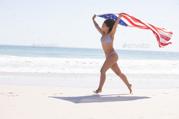 Energetic African American Woman Running on the Beach