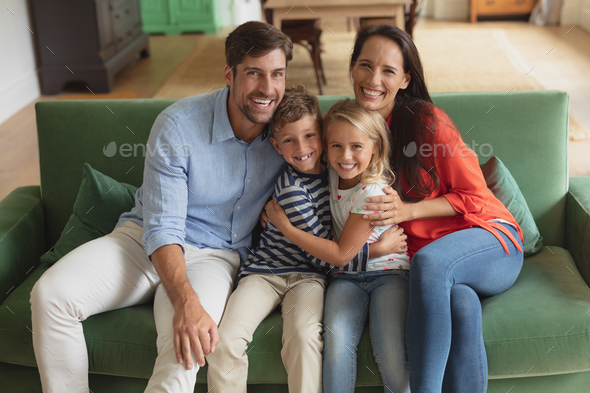 Portrait of Caucasian family sitting together on sofa in living room art home