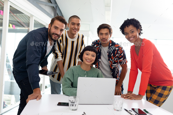 Portrait of diverse Business people discussing over laptop in the conference room at office