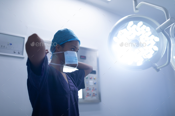 Young Mixed-race female surgeon wearing surgical mask in operation theater