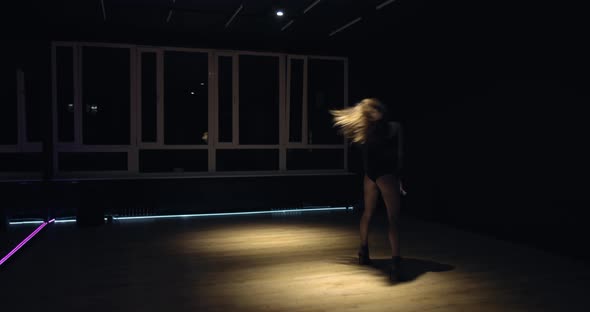 Neon Lights Along the Floor Young Woman Is Dancing in the Gym Film Grain alt