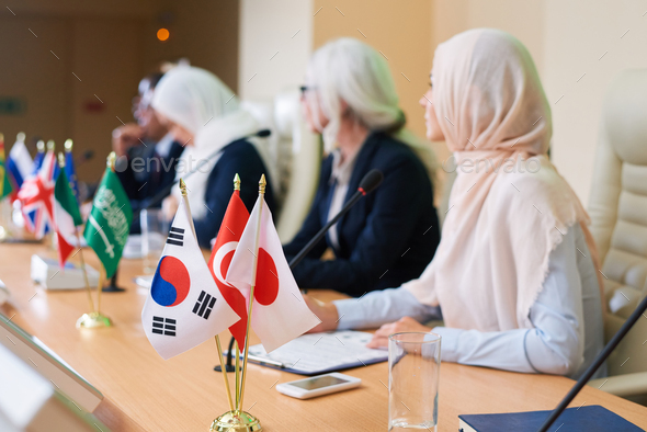 Bunch of flags of several foreign countries on table