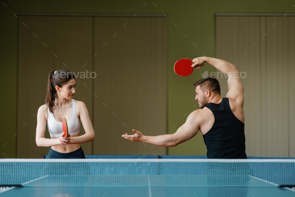 Man and woman on ping pong training indoors