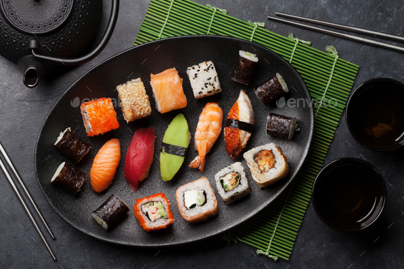 Japanese Sushi Set. Sashimi, Maki Rolls. On Plate Over Stone