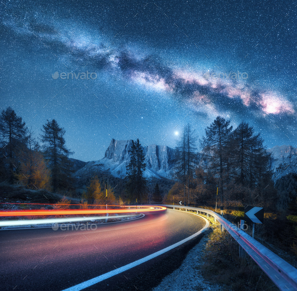 Milky Way over mountain road. Blurred car headlights - Stock Photo - Images
