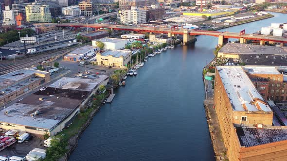 dolly shot over waterway towards the red over pass drawbridge just before sunset alt