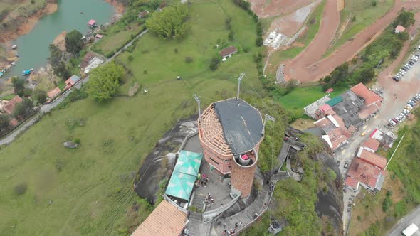 Drone flight over the summit of the Penol in Guatape, Antioquia, Colombia - aerial shot alt
