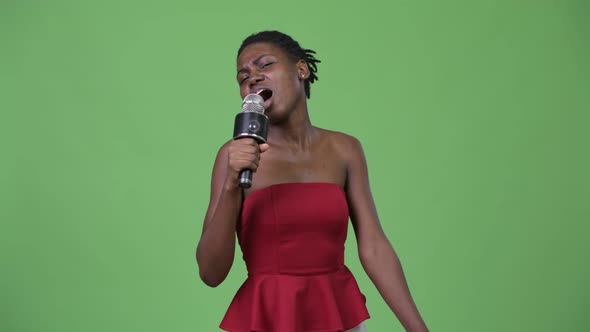 Young Beautiful African Woman Using Microphone