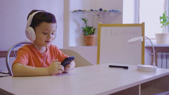 A Little Boy Learns Music at an Online School and Sends an Air Kiss