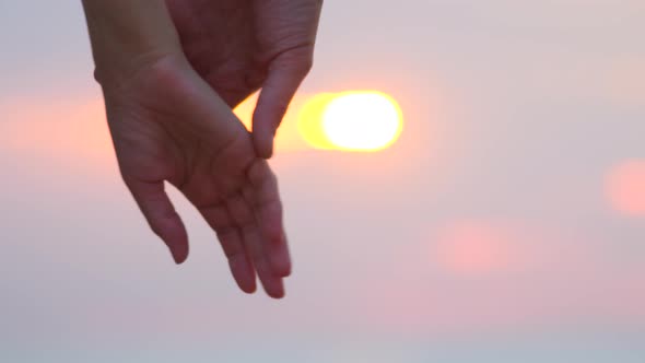 Man and woman holding hands over the sunset blur background. Couple trust Love and happiness