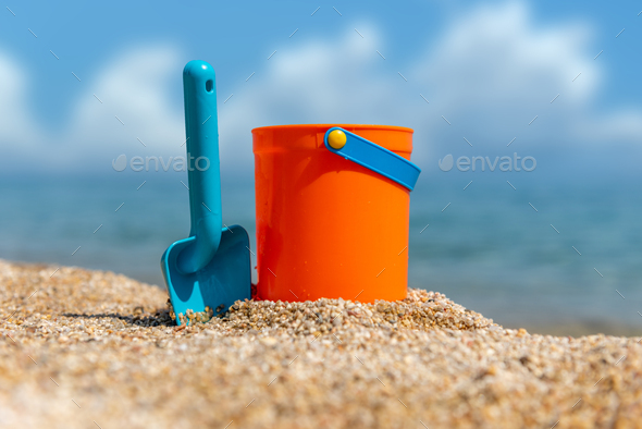 Children's beach toys - buckets and spade on sand in a sunny day - Stock Photo - Images