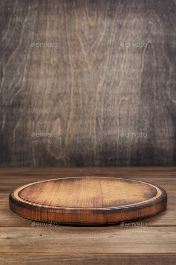 pizza cutting board at rustic wooden table Stock Photo by seregam